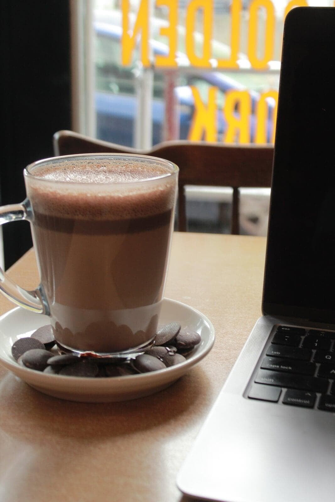 A hot drink next to a laptop at our bar