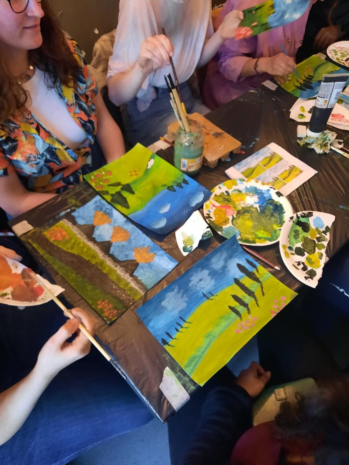 People painting landscapes together at Crafty Monday