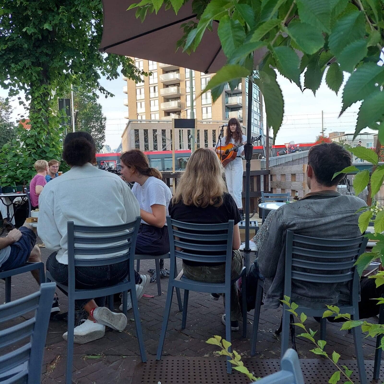 A singer with a guitar playing for guests on our terrace